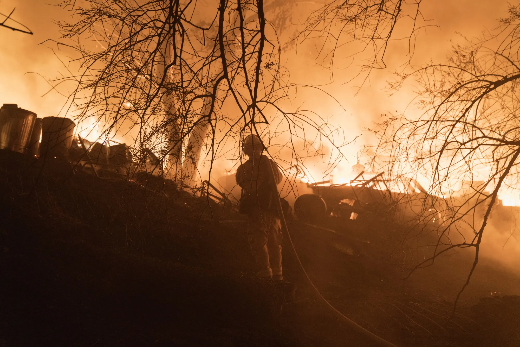 Firefighters battle flames after a structure burned during the Fairview Fire in Hemet, California, on&nbsp;Sept. 5.