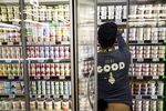 An employee stocks yogurt for sale on the opening day of the 365 by Whole Foods Market store in the Silver Lake neighborhood of Los Angeles, Calif. on May 25, 2016.

