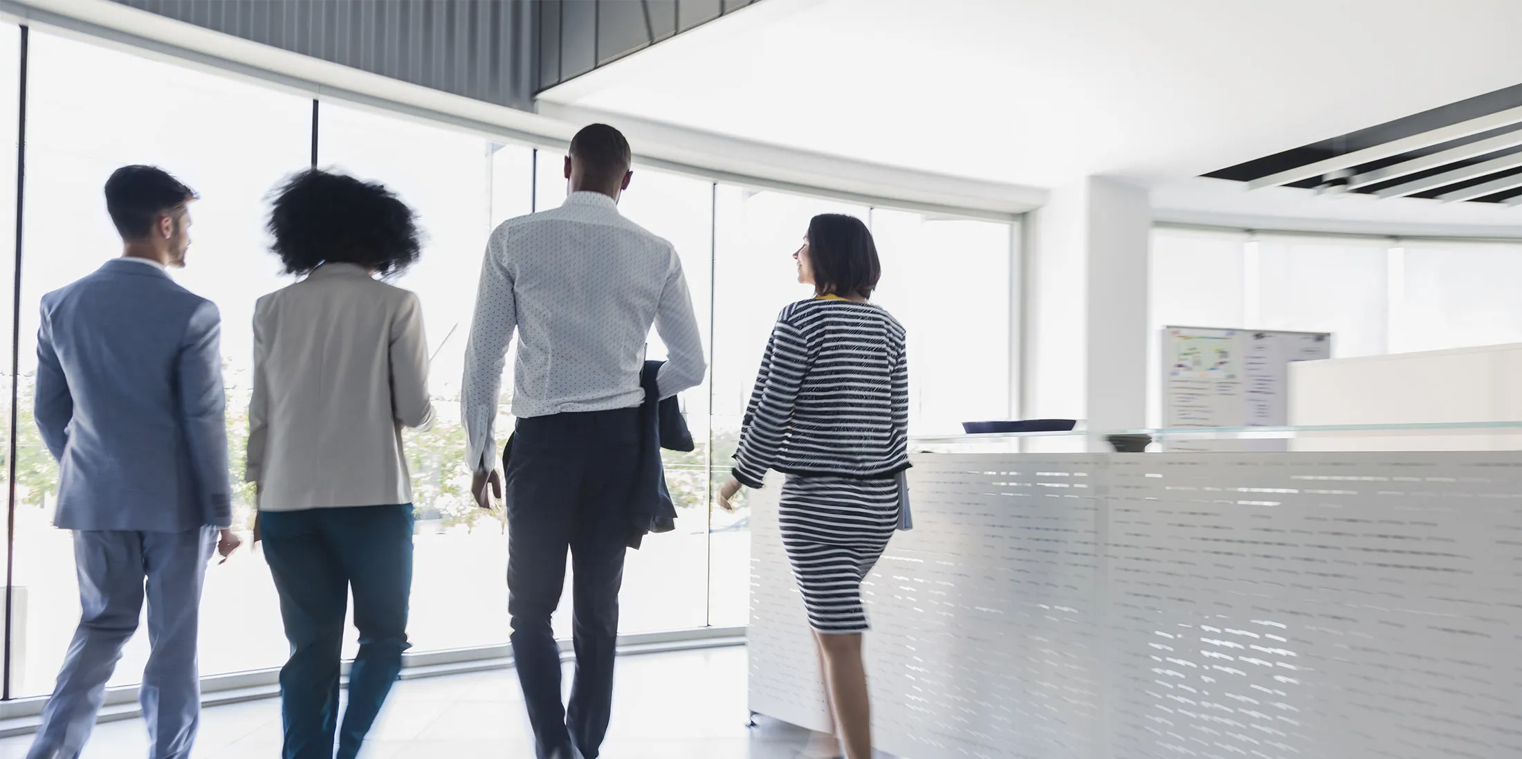 Business people walking in office lobby