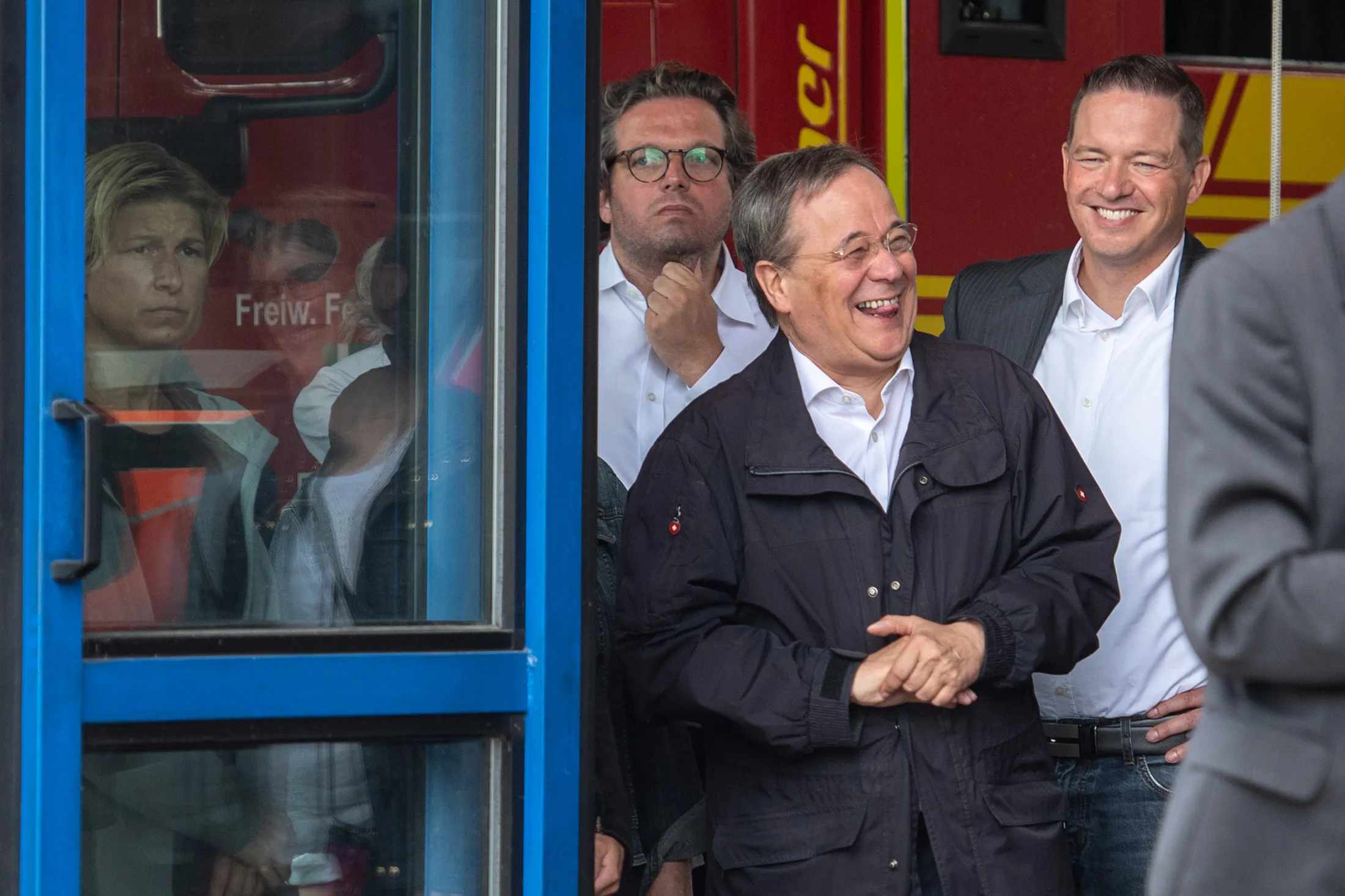 Armin Laschet laughs while President Steinmeier gives a press statement in North Rhine-Westphalis, Erftstadt on July 17.
