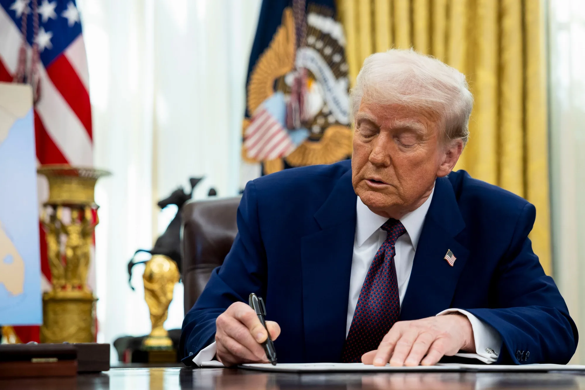 Donald Trump signs an executive order proposing new tariffs at the White House in Washington&nbsp;on Feb. 13.