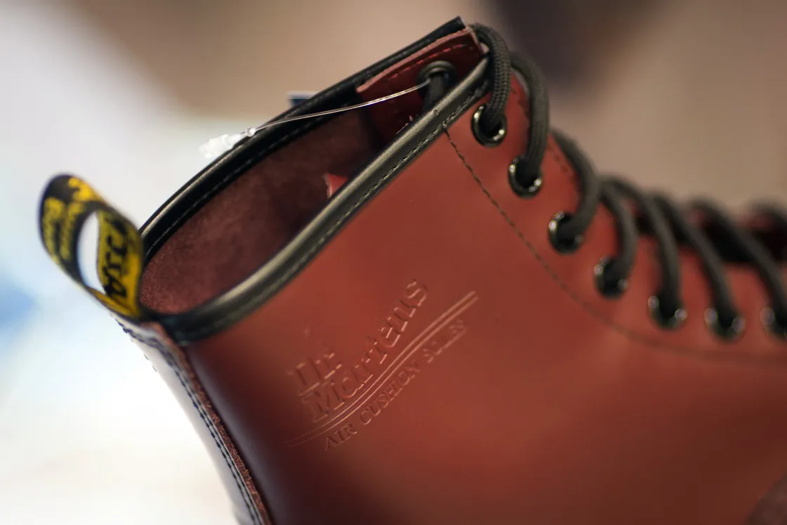 A logo sits on the side of a Dr. Martens boot.