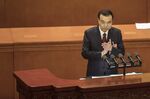 Li Keqiang, China's premier, applauds as he delivers a speech during the opening of the first session of the 13th National People's Congress (NPC)