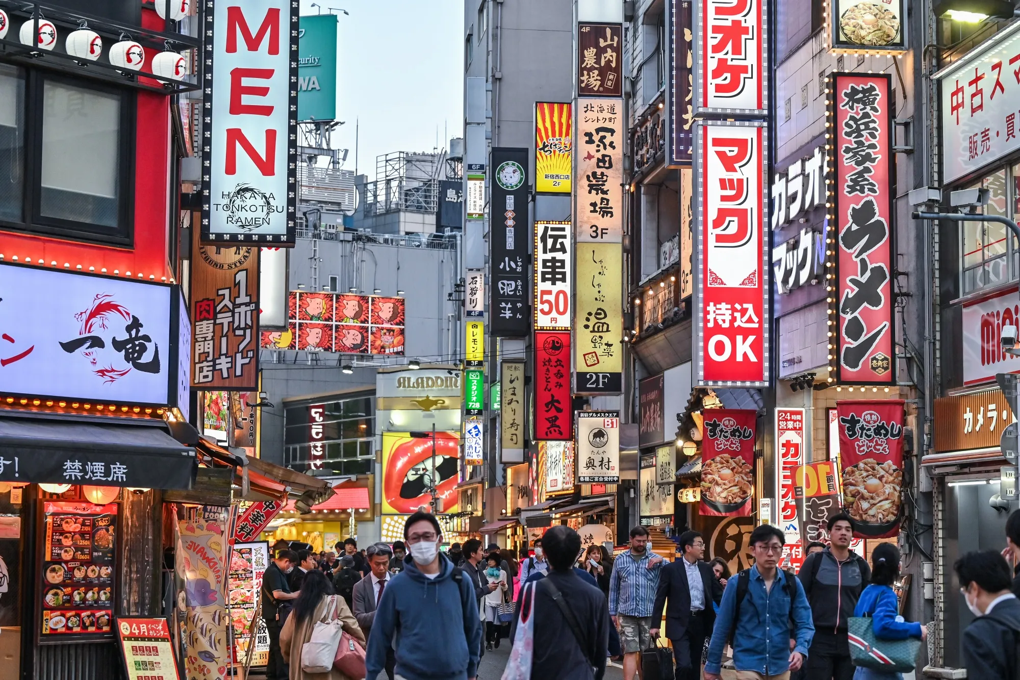 People walk past bars and restaurants in&nbsp;Tokyo.