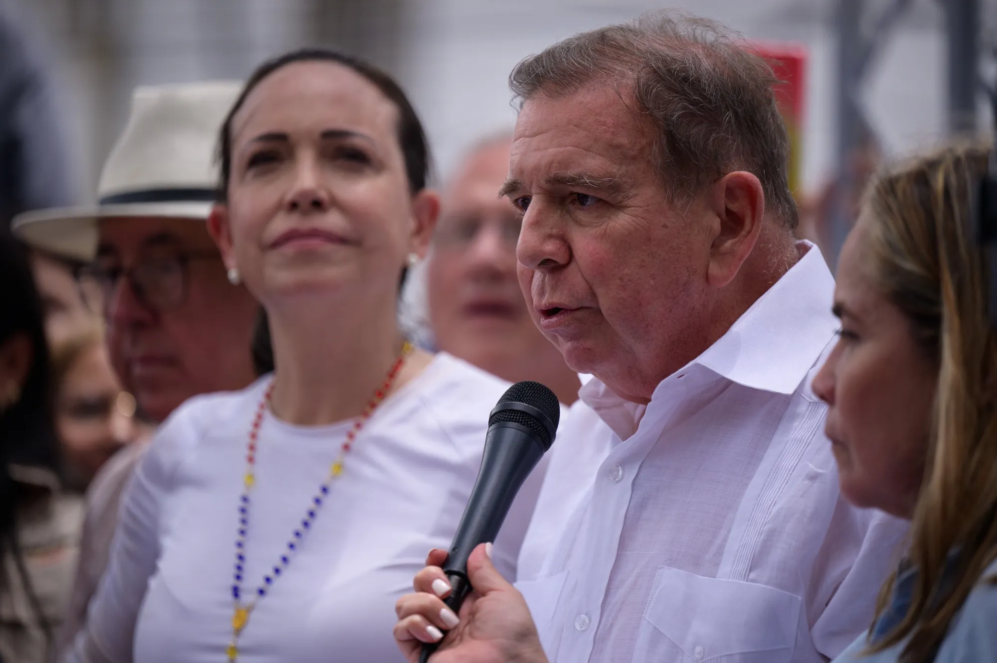 Edmundo Gonzalez, center right, speaks next to Maria Corina Machado