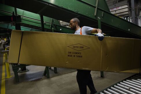An employee unloads an oversized package at a FedEx Corp. Ground distribution center.