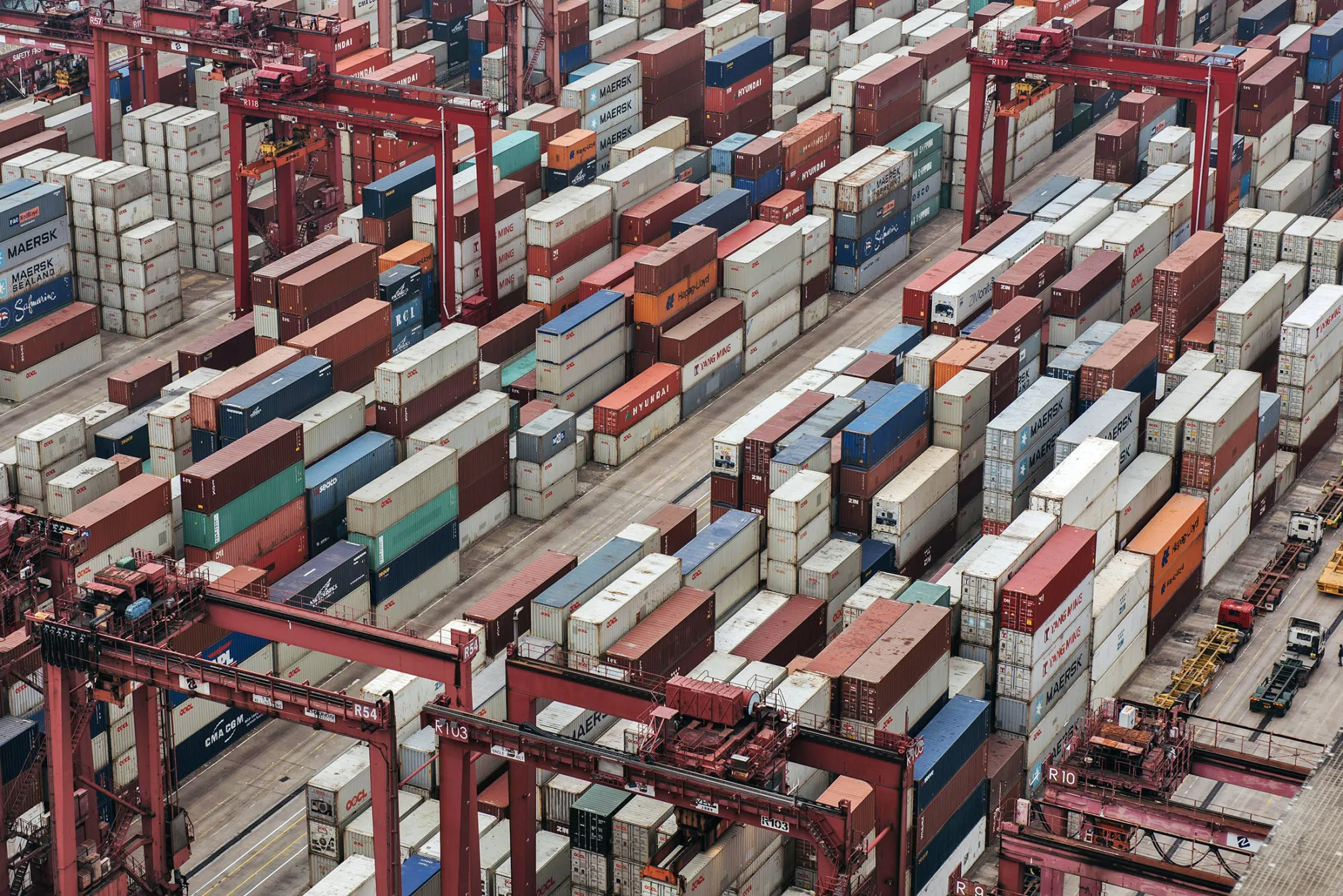 Shipping containers sit stacked among gantry canes at the Kwai Tsing Container Terminals, operated by Hong Kong International Terminal (HIT), a unit of CK Hutchison Holdings Ltd., in Hong Kong.
