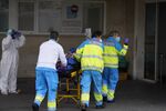Paramedics wheel a patient on a stretcher into the emergency department of a hospital in Madrid on March 30.