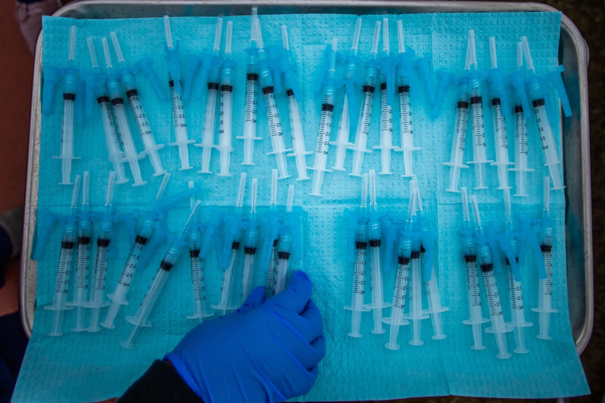 A nurse prepares vaccines at a vaccination site in Los Angeles.