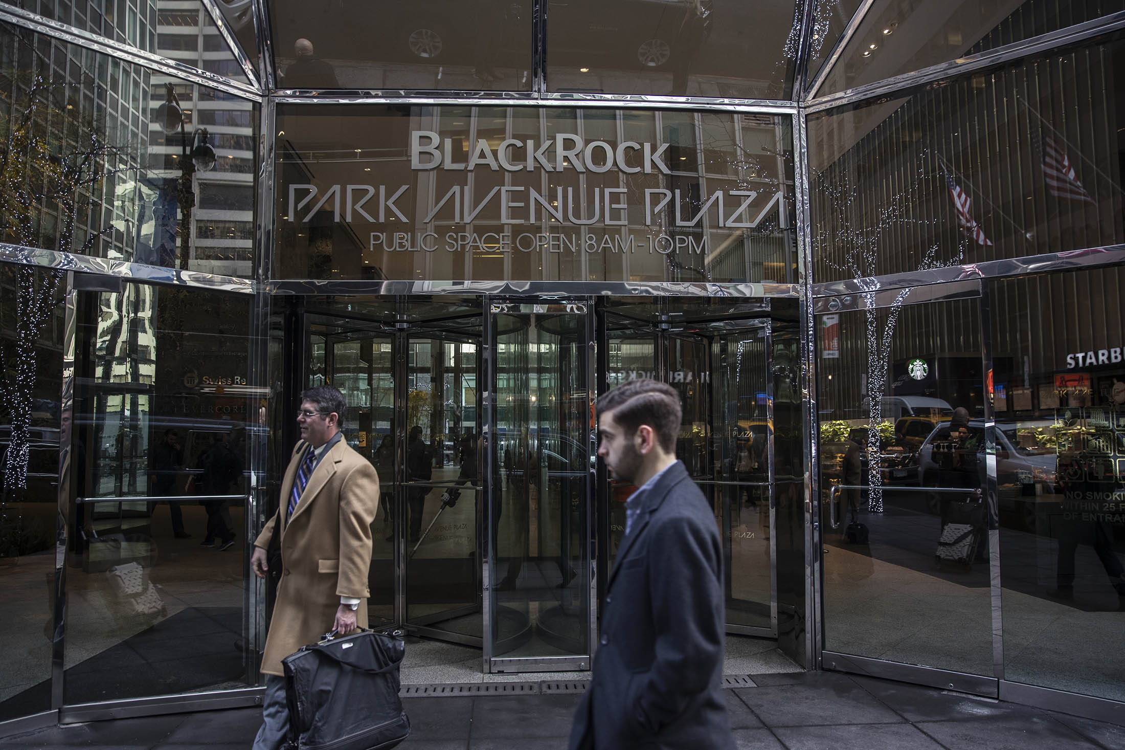 Pedestrians pass in front of BlackRock Inc. headquarters in New York.
