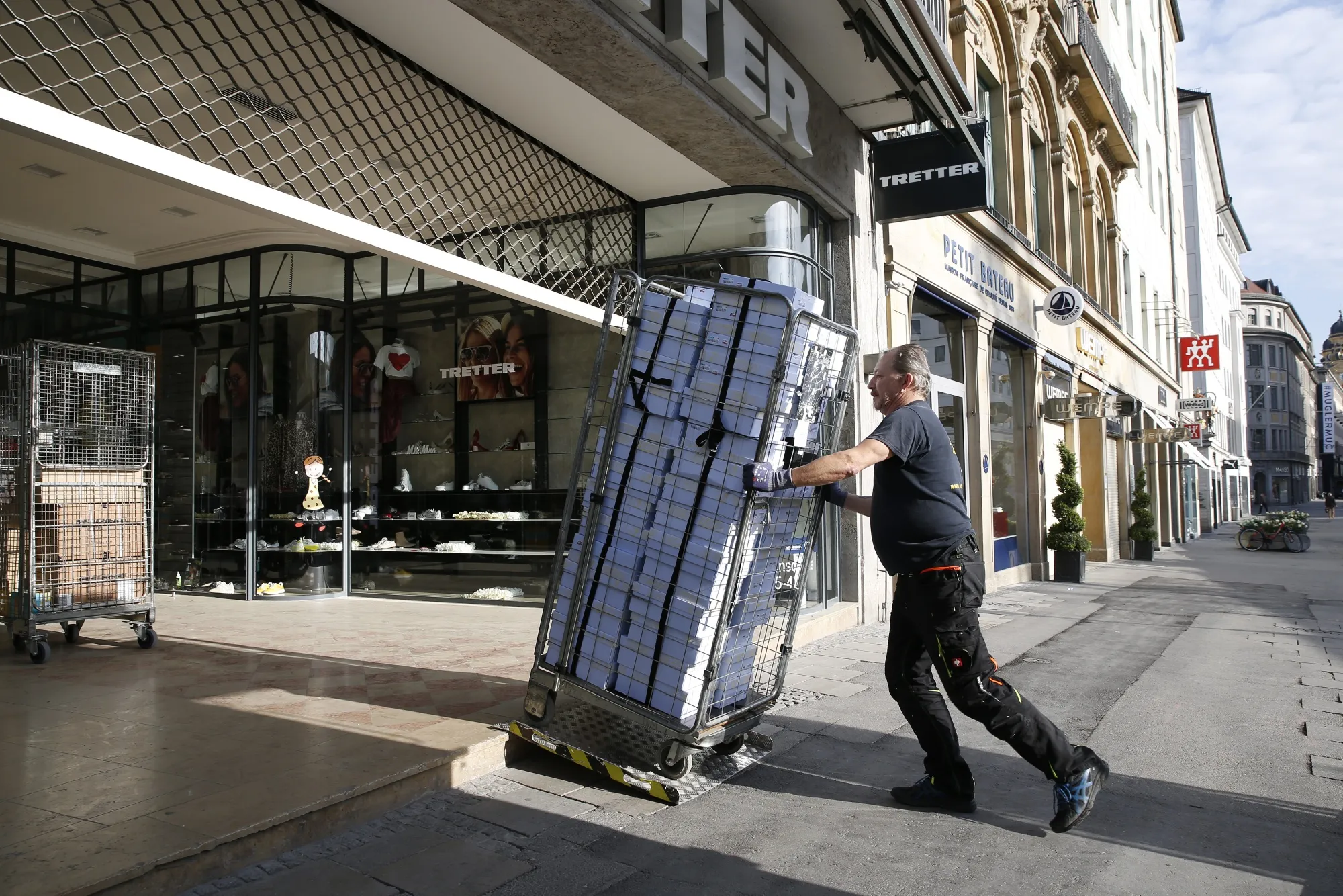 A worker delivers footwear to a shoe shop ahead of opening next week as coronavirus lockdown measures are slowly relaxed, in Munich on April 17.