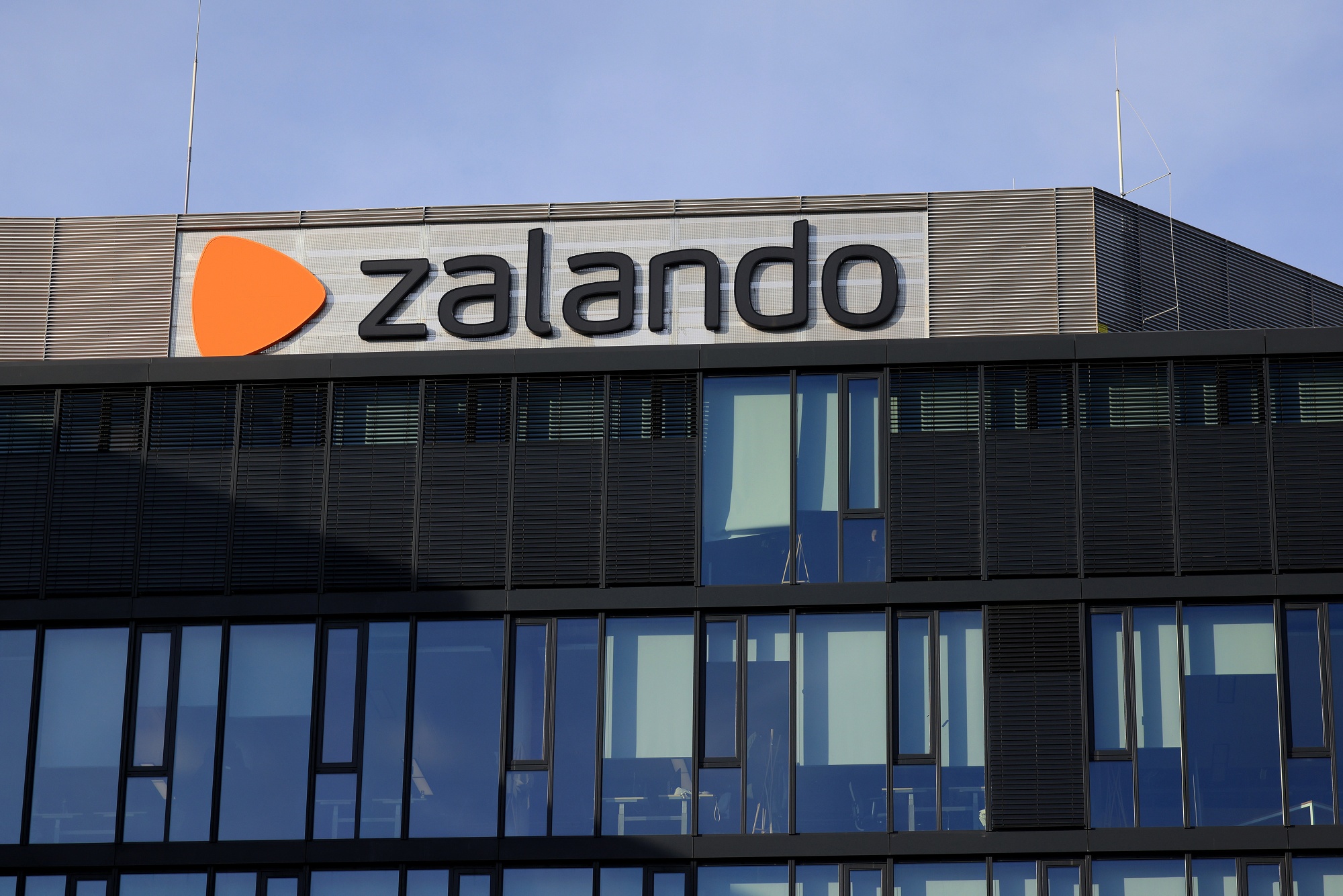 The logo of Zalando SE at the online retailer's headquarters in Berlin, Germany, on Thursday, Feb. 9, 2023. Berlin’s new tech recruits are being told to take any apartment they can get as the city's housing crunch means startups in Berlin have lost an important edge, putting them on similar footing to rivals in London, Paris and Silicon Valley.