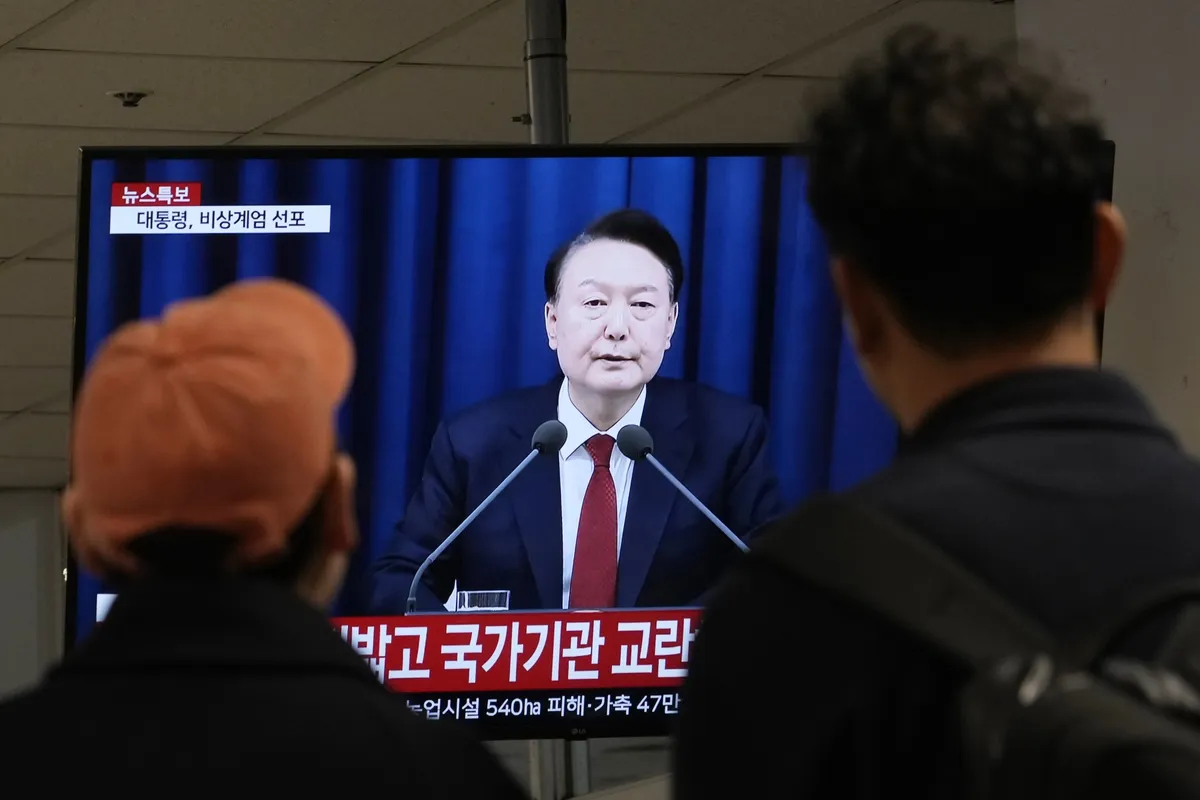 People watch Yoon Suk Yeol’s national televised address in Seoul, on Dec. 3.Photographer: Ahn Young-joon/AP Photo