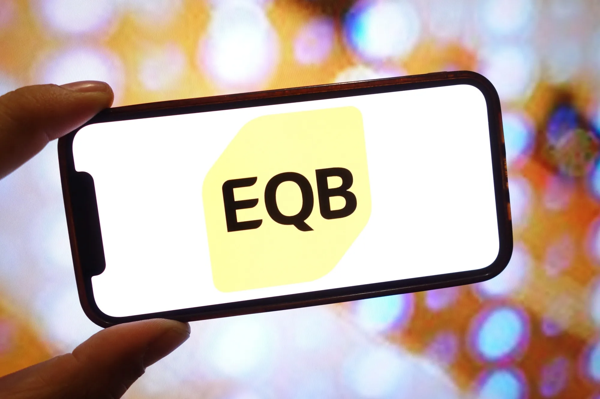 EQB Inc. logo displayed on a smartphone.