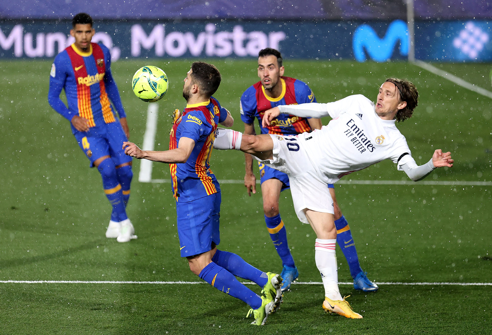 Real Madrid's Luka Modric, right, heads the ball past Manchester