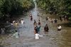 Residents cool off in a river canal during a heat wave Lahore, Pakistan, as temperatures reach 40°C. Photo by Arif ALI / AFP