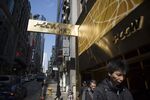 Pedestrians walk past a PCCW Ltd. store in Hong Kong.