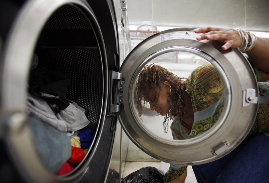 A woman washes her clothes at a Laundromat in Cambridge, Massachusetts. 