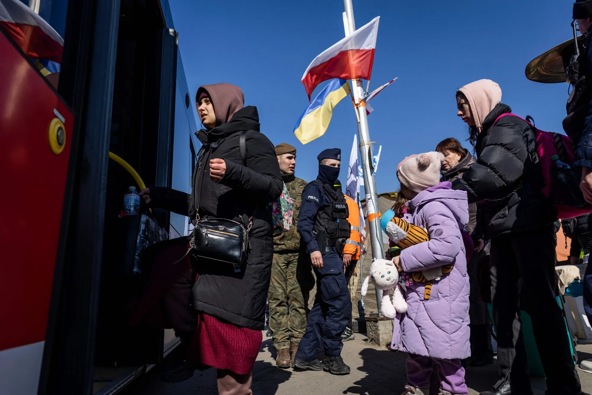 Refugees board buses after crossing from Ukraine, in Medyka, Poland, on March 17. The number of refugees reaching Poland from Ukraine now exceeds 2 million.