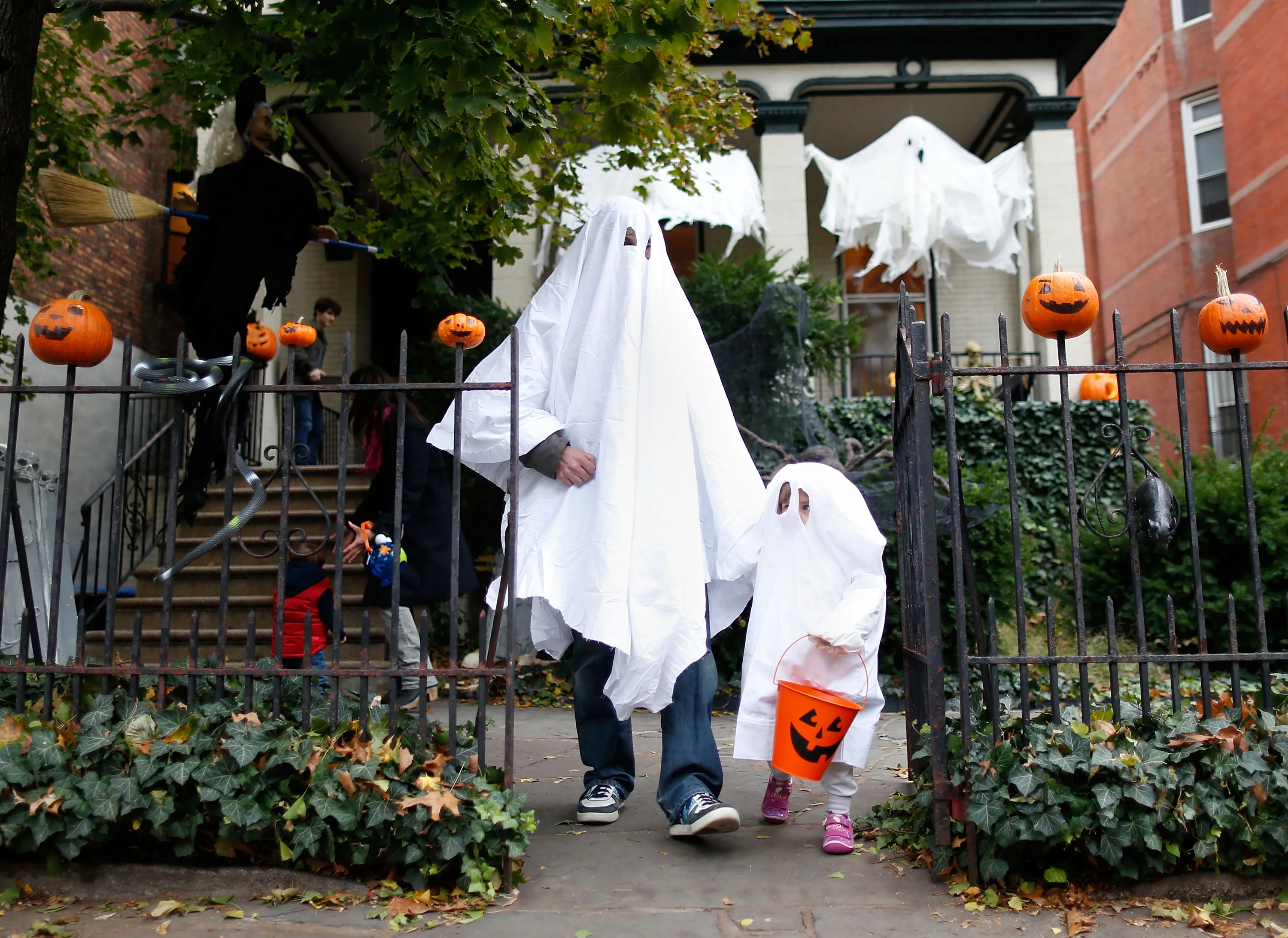 A family trick-or-treating in Fort Greene, Brooklyn.&nbsp;The unusually warm Halloween is part of a decades-long warming trend.