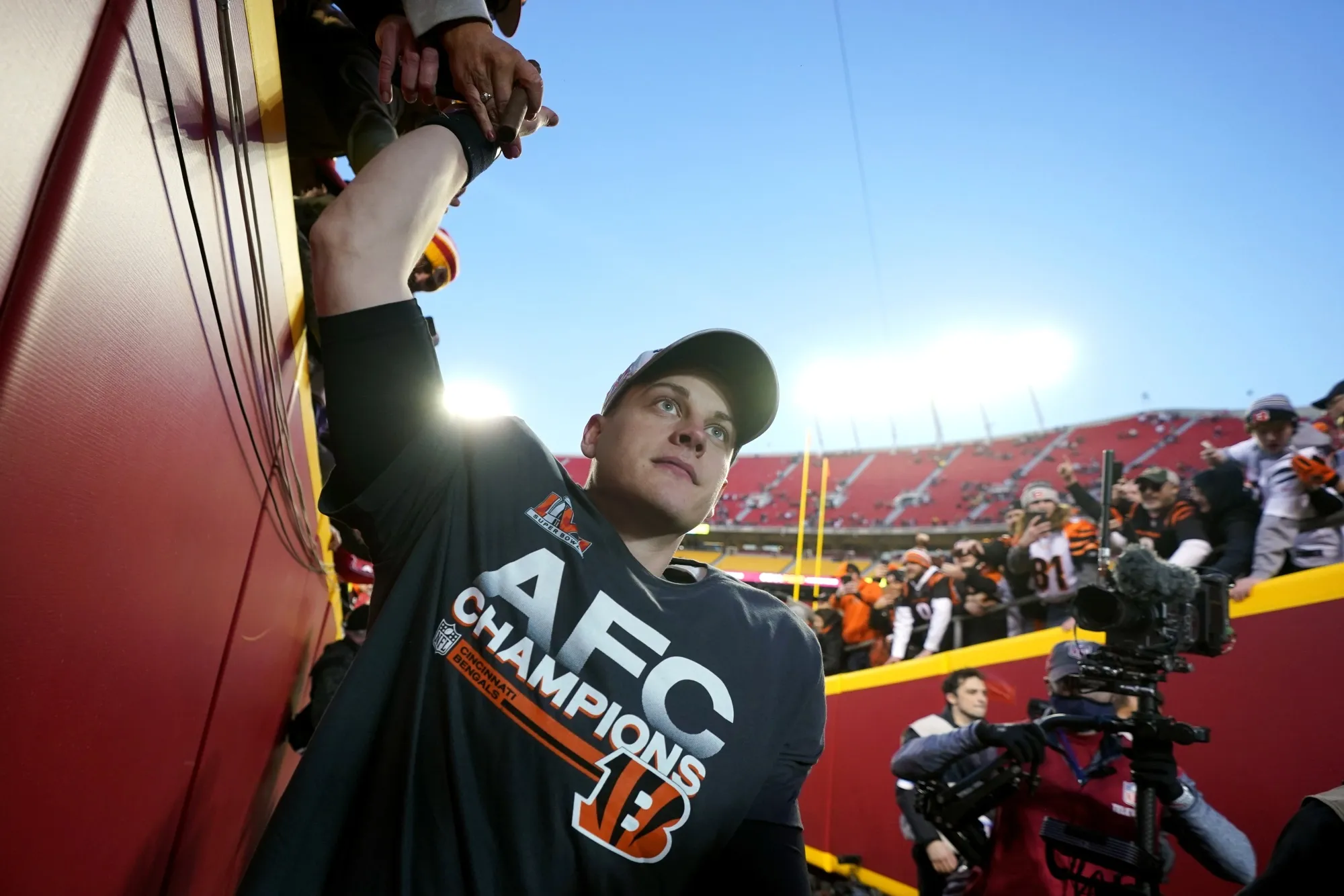 Cincinnati Bengals quarterback Joe Burrow celebrates with fans after the AFC championship NFL football game against the Kansas City Chiefs, Sunday, Jan. 30, 2022, in Kansas City, Mo. The Bengals won 27-24 in overtime. (AP Photo/Paul Sancya)