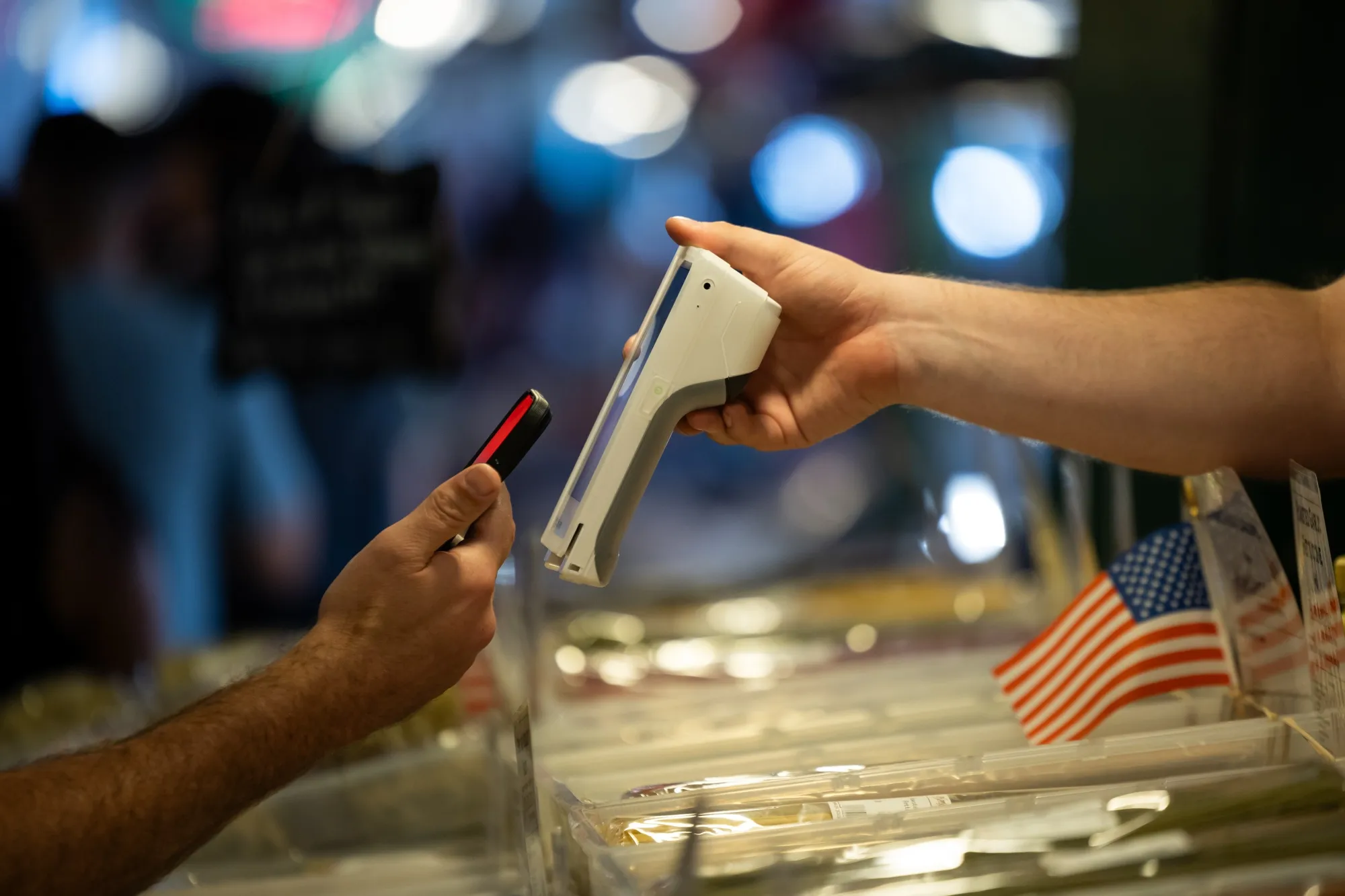 A customer uses a smartphone to pay for a purchase&nbsp;in Seattle.