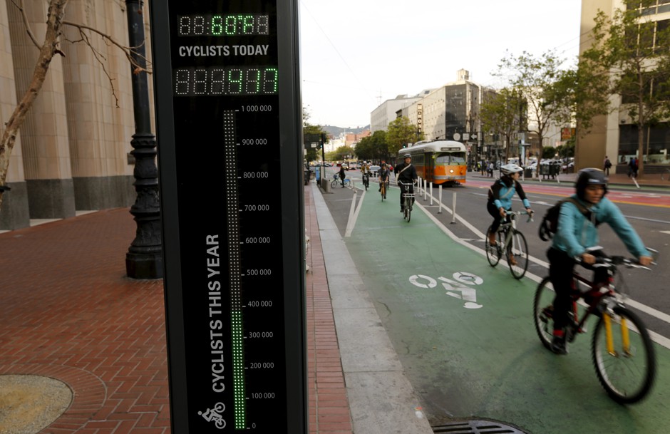Cyclists riding past a bike counter in downtown San Francisco 