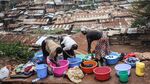 People wash clothes in the Kibera slum, located in Nairobi, Kenya.
