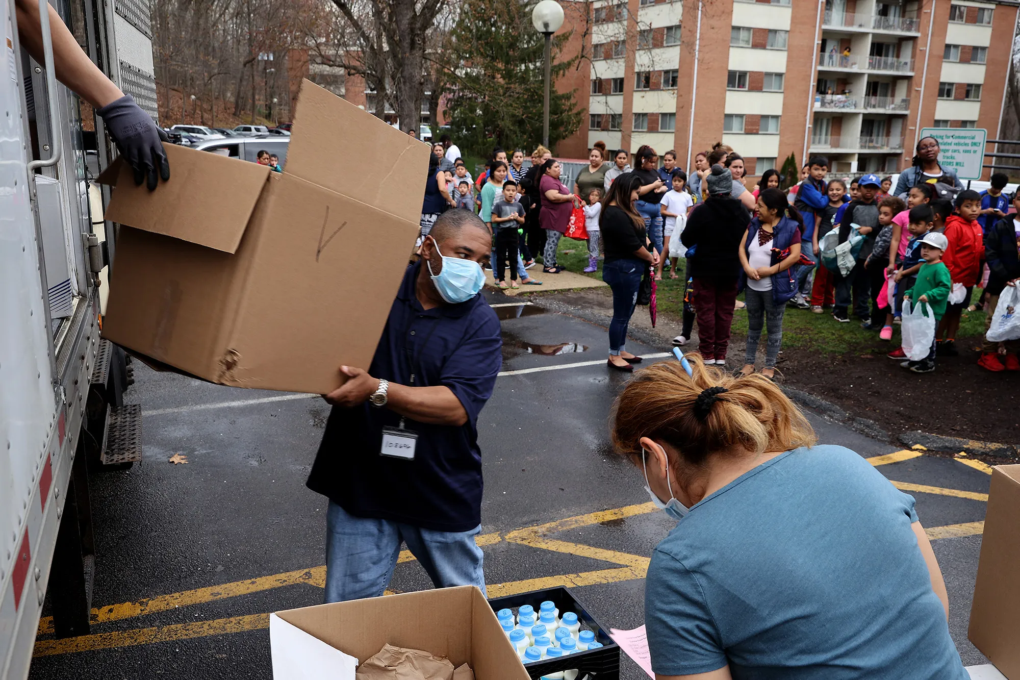 People&nbsp;wait in line&nbsp;to receive food distributed by Montgomery County Public Schools as part of a program to feed children while schools are closed&nbsp;in Silver Spring, Maryland, on March 20.&nbsp;