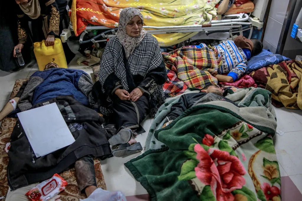 A woman sits among Palestinians at Al-Shifa hospital&nbsp;in Gaza City, on Feb. 29.