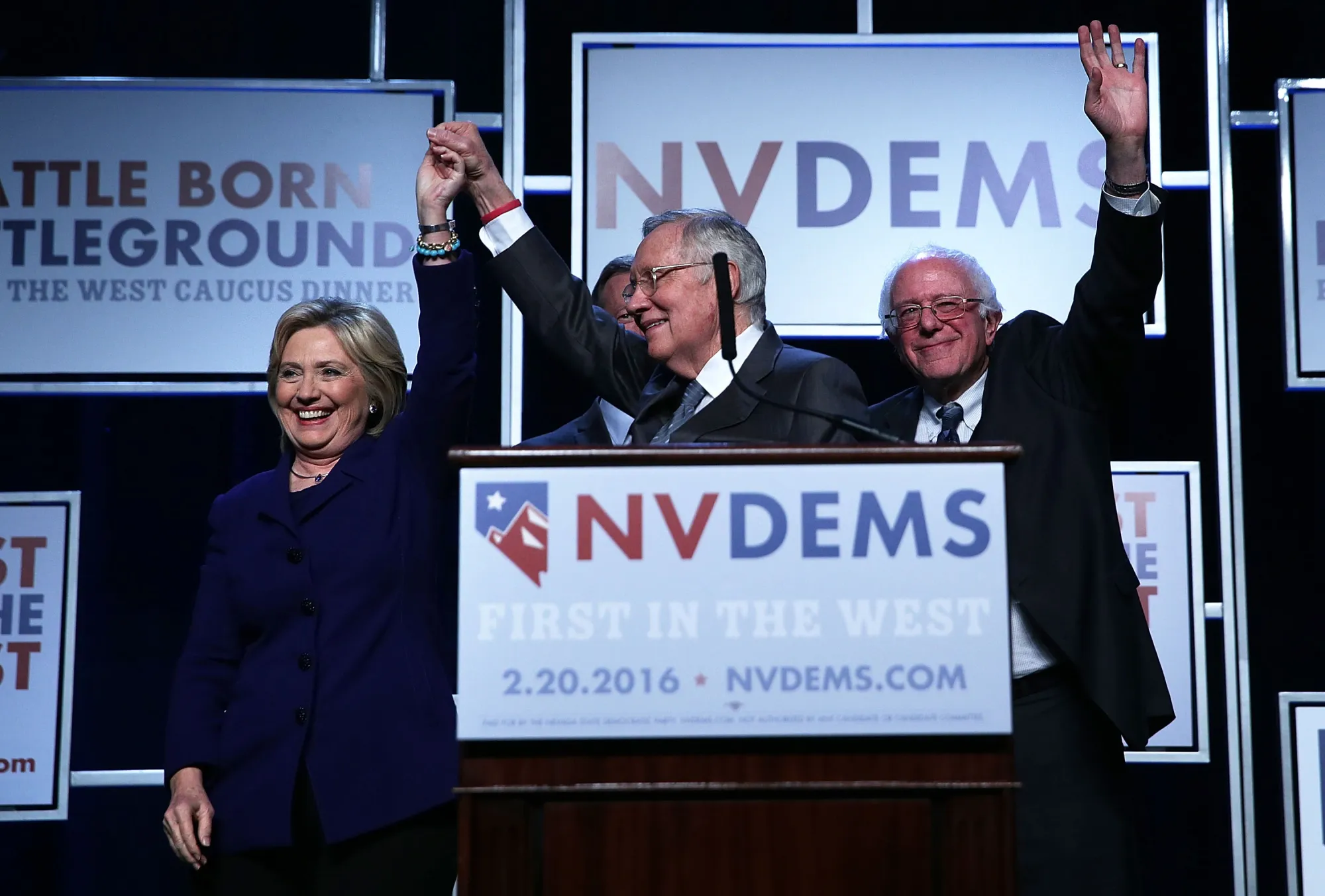 Democratic presidential candidates Hillary Clinton and Bernie Sanders appear on stage with Senate Minority Leader Harry Reid on Jan. 6, 2016, in Las Vegas.
