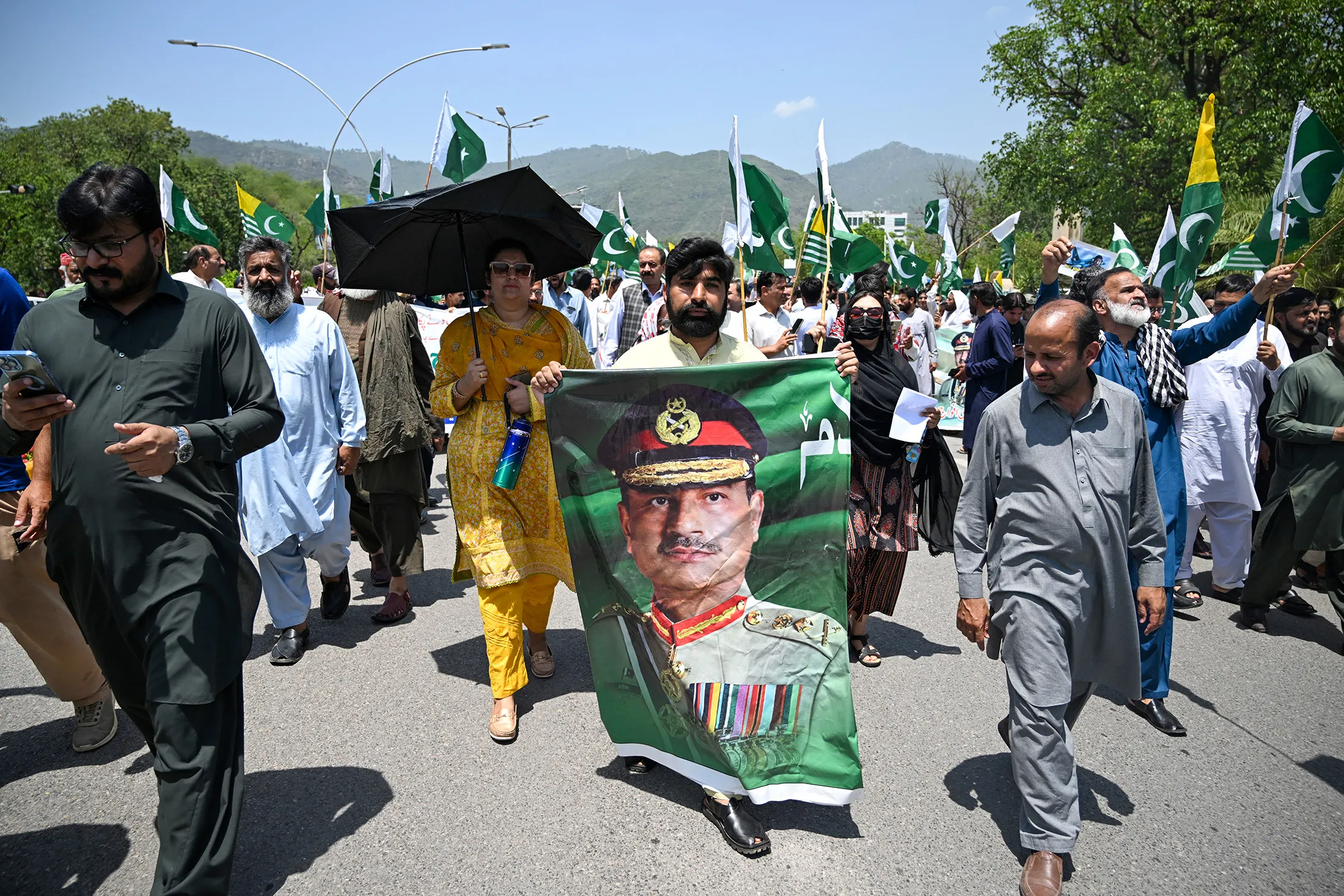 A man carries a portrait of Pakistani Army Chief General Asim Munir, during a rally to express solidarity with Pakistan's armed forces&nbsp;in Islamabad on May 14.