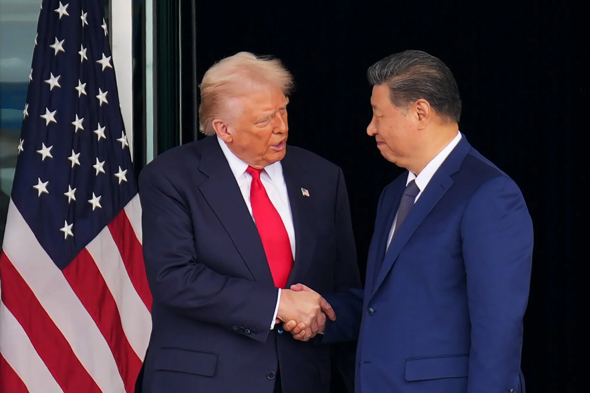 Donald Trump and Xi Jinping shake hands as they leave after their talks in Busan.