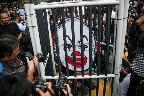 Malaysian activist with a caricature of Najib Razak’s face on Aug. 27.