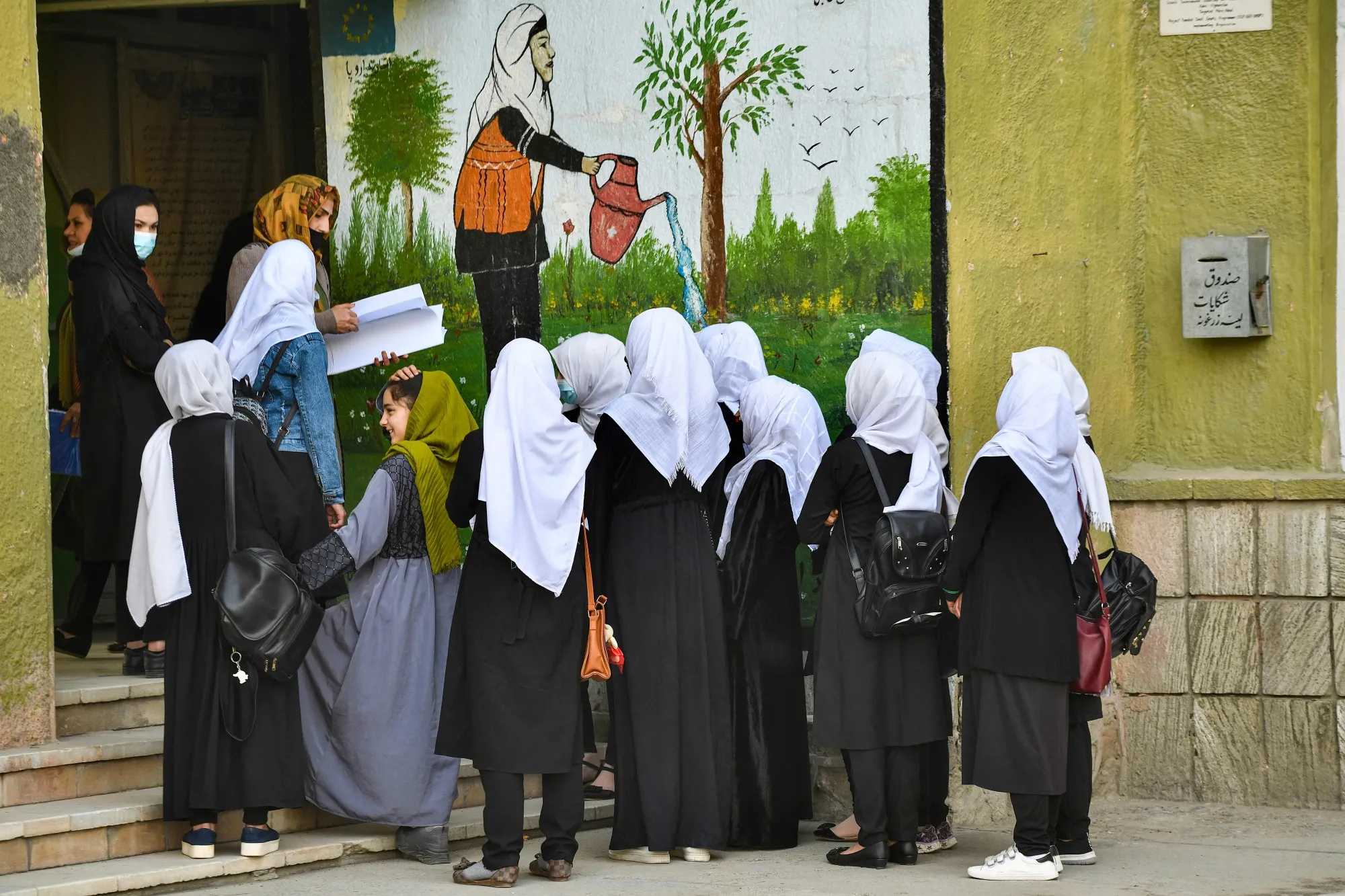 Girls arrive at their school in Kabul on March 23.
