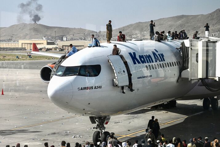 Photos: People Scaling Planes at Kabul Airport to Flee Taliban
