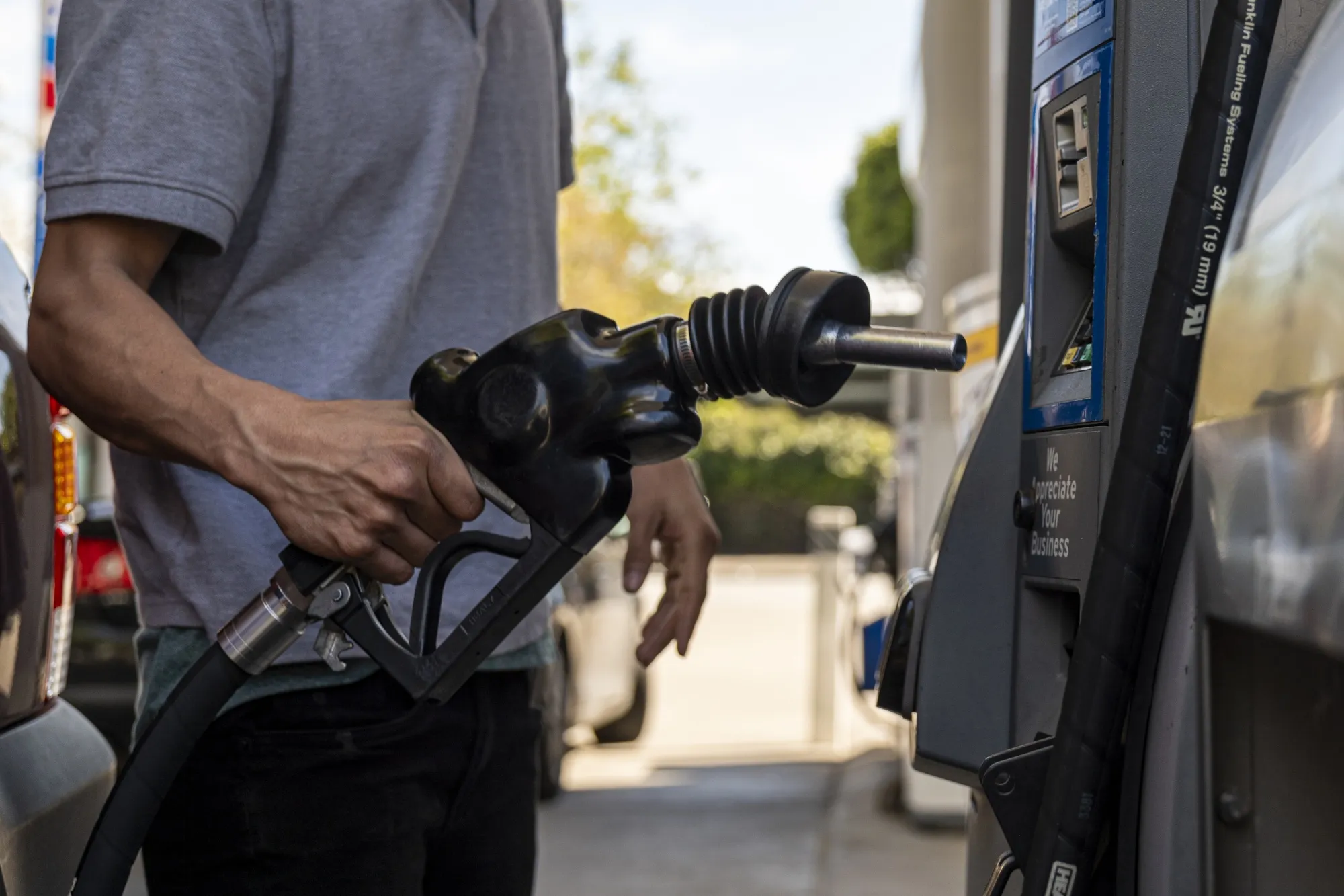 A driver returns a fuel nozzle to a gas pump at a Chevron gas station in San Francisco, California.