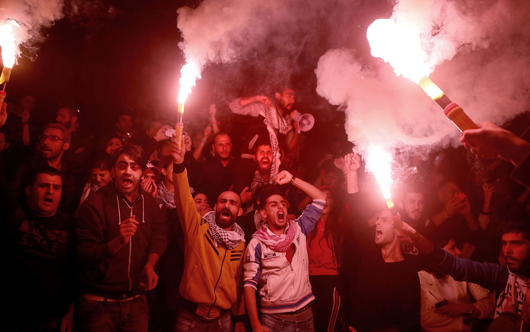 Lebanese anti-government protesters shout slogans outside the headquarters of the Central Bank in Beirut on Nov. 28.