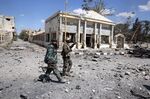 Syrian soldiers walk in the residential neighbourhoods near the ancient Syrian city of Palmyra on March 31.
