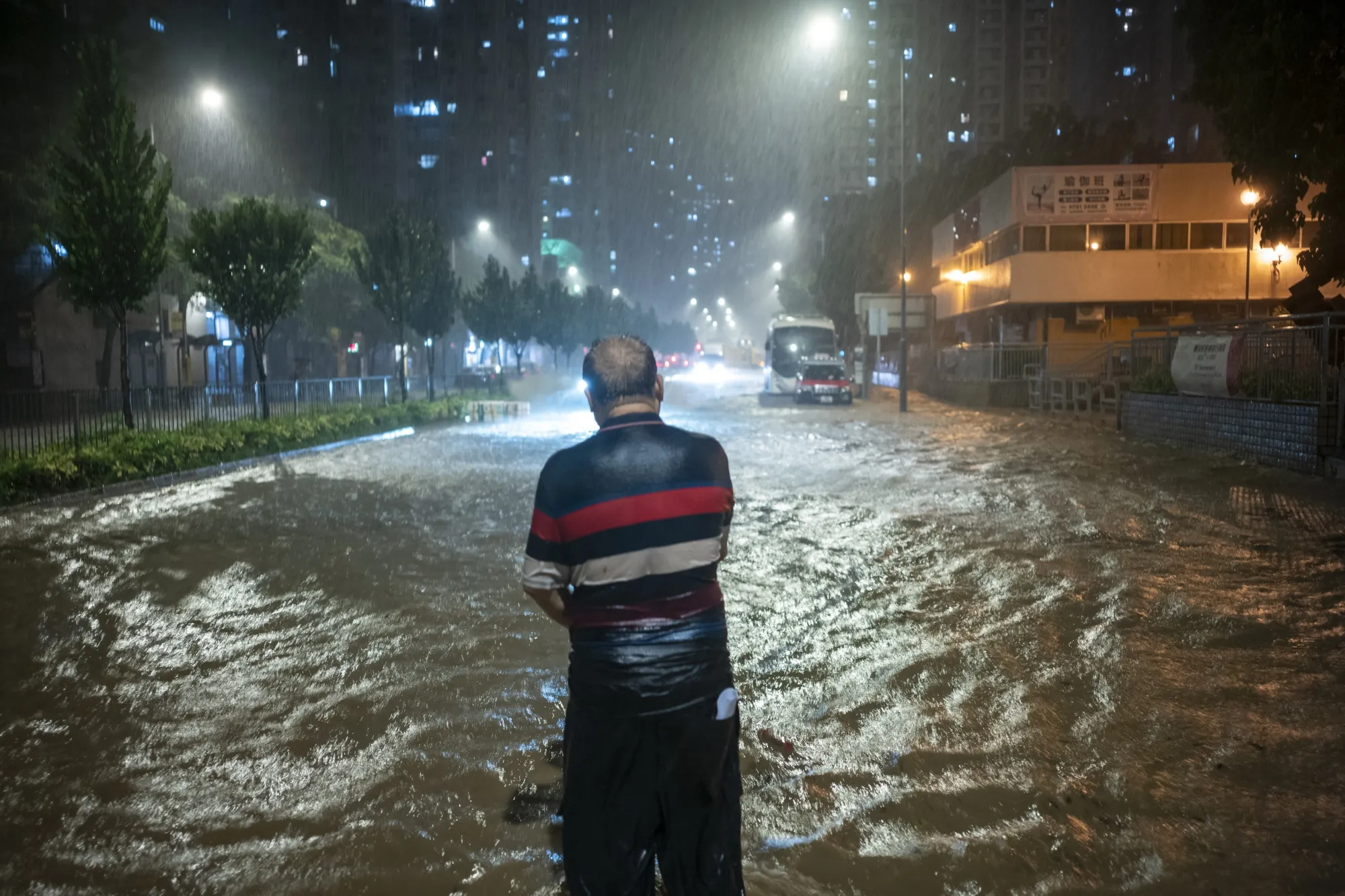A pedestrian in floodwaters during heavy rain in Hong Kong in 2023.