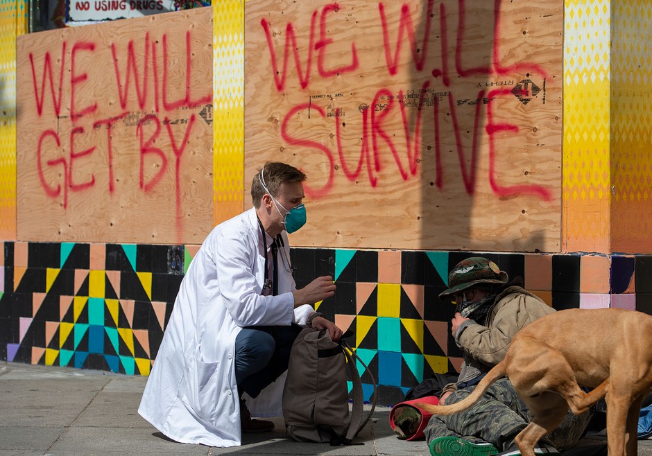 Stuart Malcolm, a doctor with the Haight Ashbury Free Clinic, speaks with homeless people about the coronavirus in San Francisco.