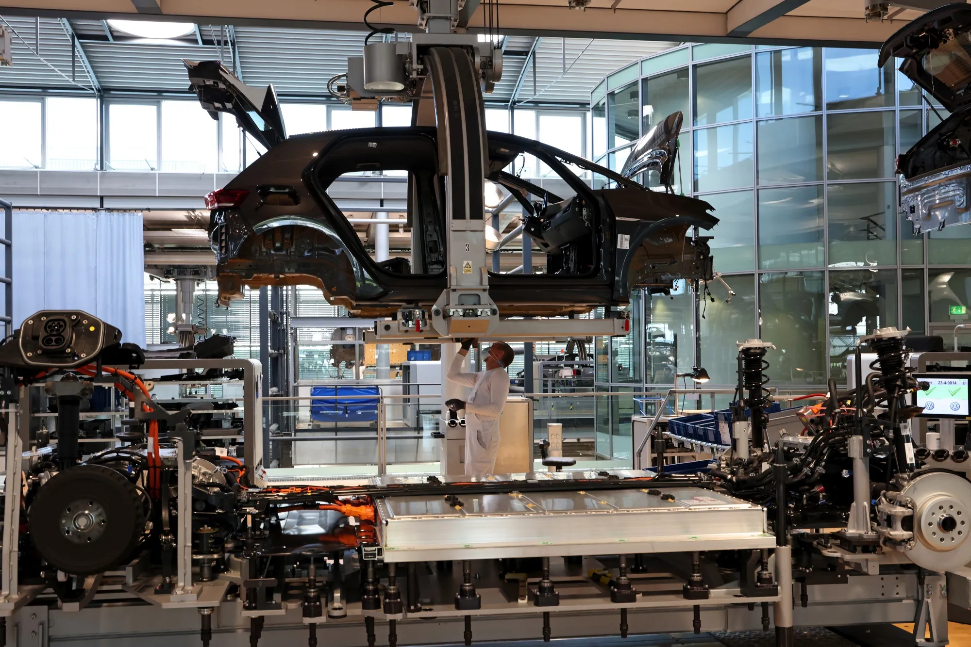 A worker prepares the undercarriage of a Volkswagen AG&nbsp;ID.3 electric automobile&nbsp;in Dresden, Germany.