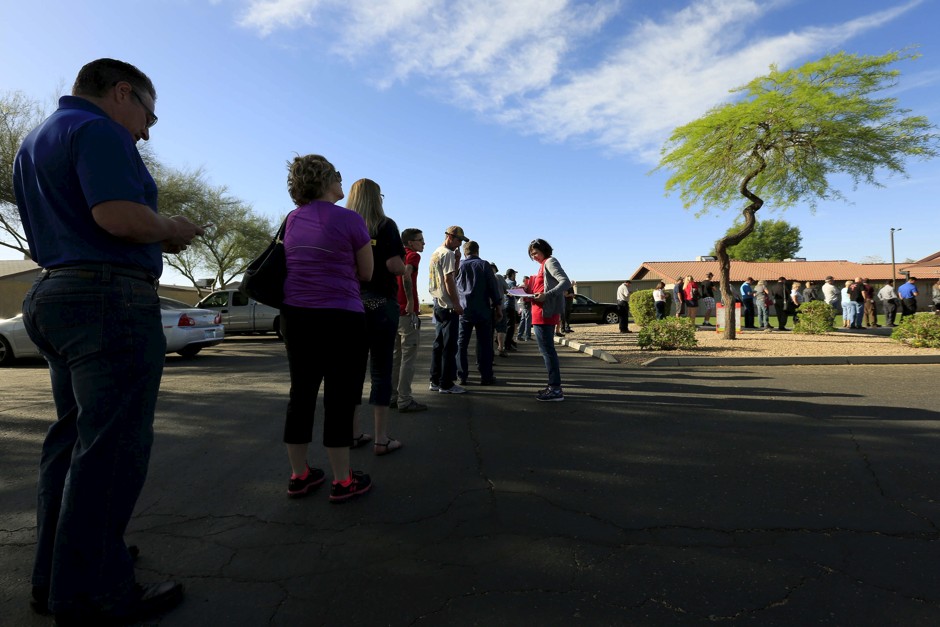 People wait to vote in the U.S. presidential primary election outside a polling site in Arizona.