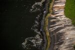Trash floats near the rocky shores of Niteroi at the Guanabara Bay in this aerial photograph taken above Rio de Janeiro, Brazil, on Saturday, Feb. 13, 2016.
