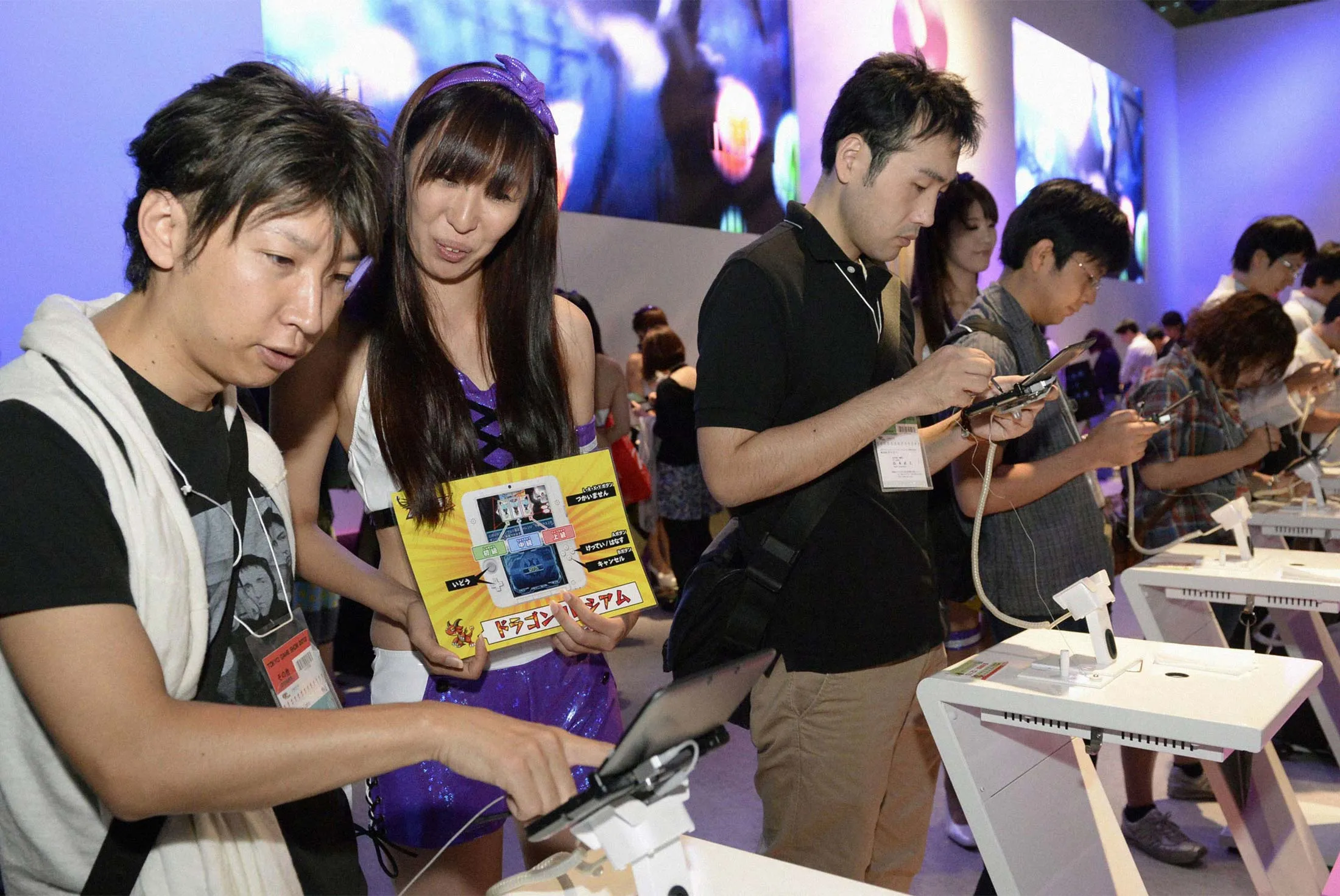 Visitors at the Tokyo Game Show, one of the world’s largest gaming events, play Puzzle &amp; Dragons on Nintendo Co.’s portable device at the Makuhari Messe convention center near Tokyo on Sept. 19, 2013.