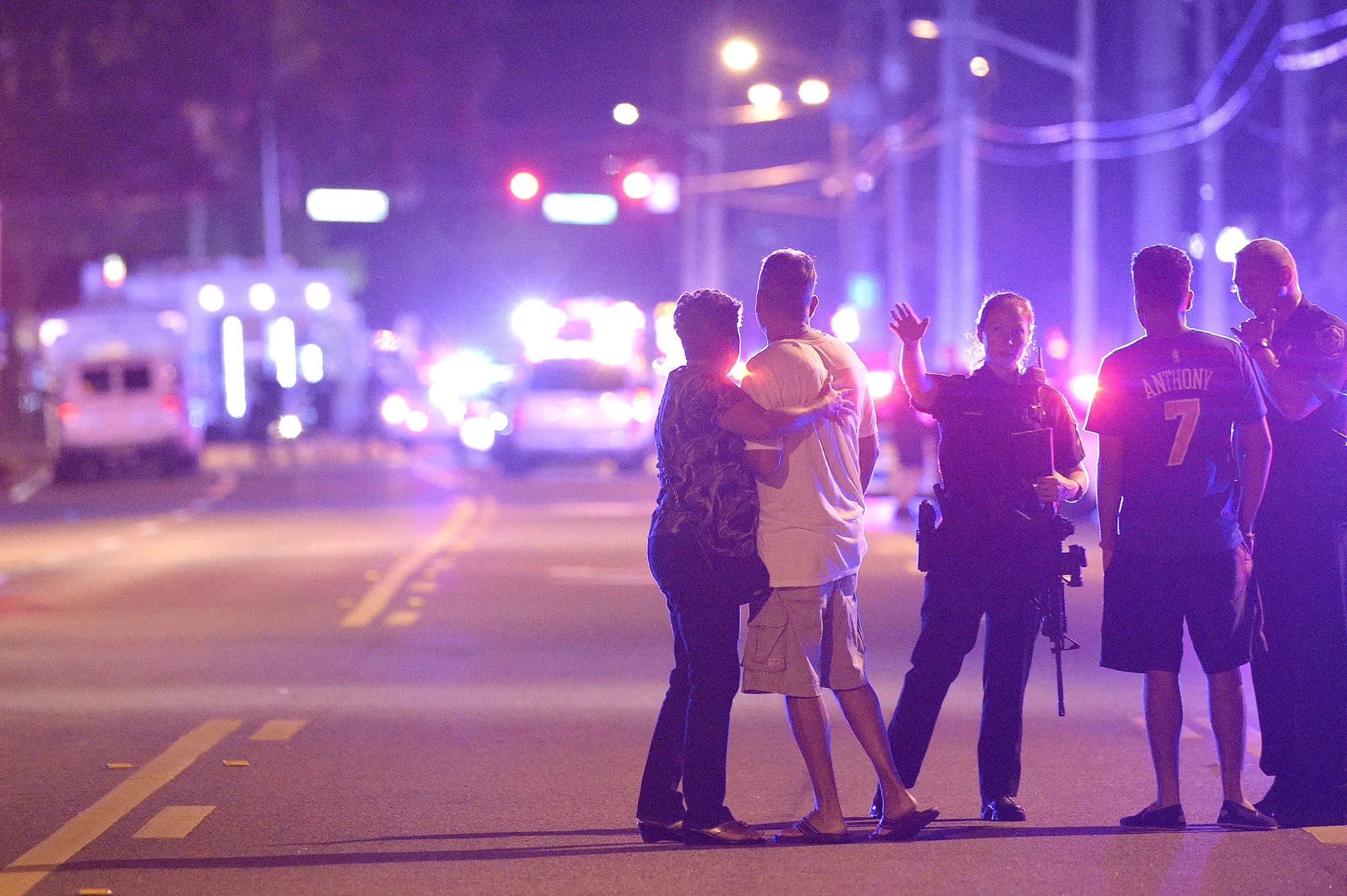 Orlando Police officers direct family members away from a multiple shooting at a nightclub in Orlando, Fla., Sunday, June 12, 2016. A gunman opened fire at a nightclub in central Florida, and multiple people have been wounded, police said Sunday.
