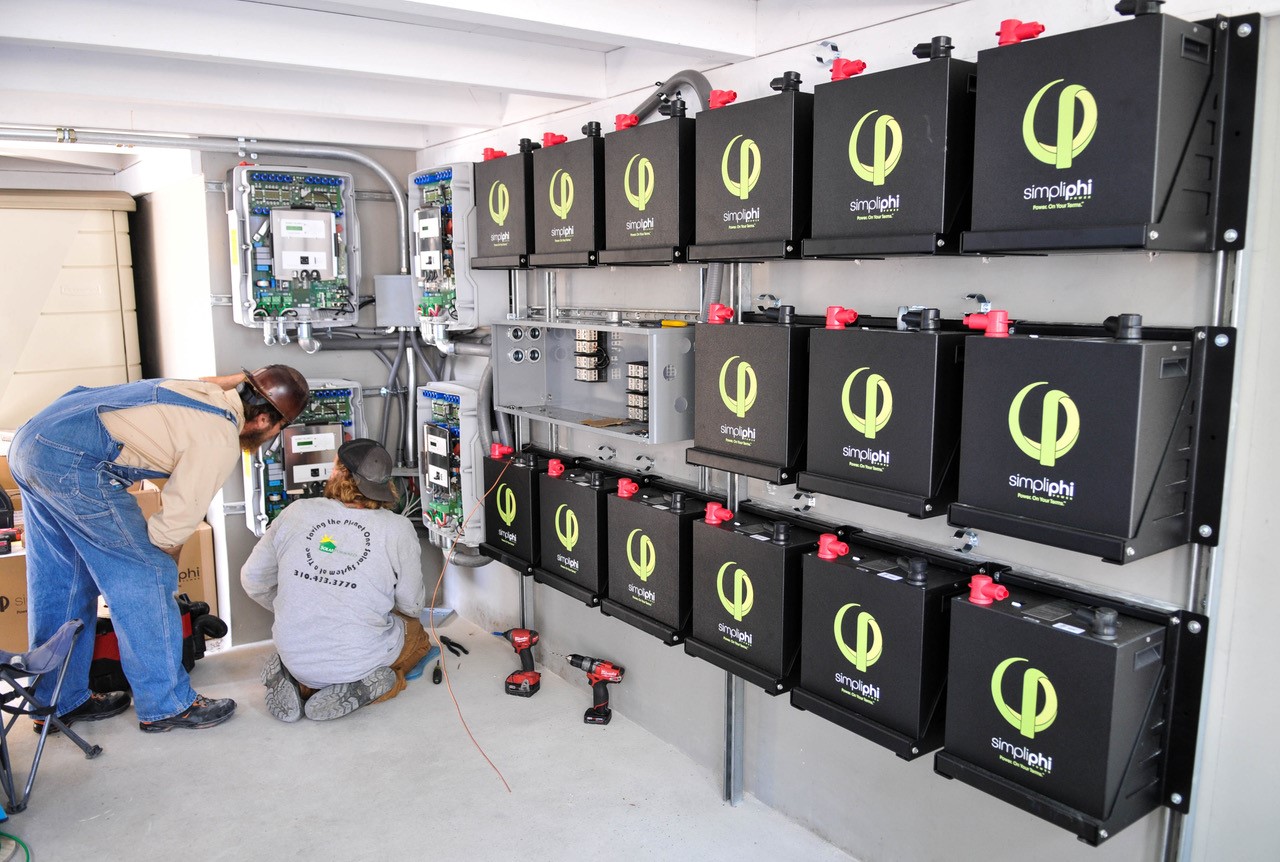 Workers installing Simpliphi batteries. 
