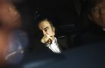 Carlos Ghosn, former chairman of Nissan Motor Co., center, sits in a vehicle as he leaves his lawyer's office in Tokyo, Japan, on Wednesday, March 6, 2018. Ghosn walked out of a Tokyo prison on bail after 108 days in detention, vowing to fight allegations of financial crimes that could imprison the former Nissan chairman for as long as a decade.