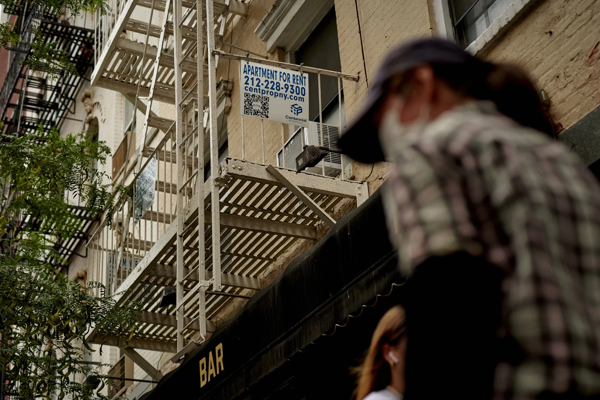 An "Apartments For Rent" sign outside a building in New York.