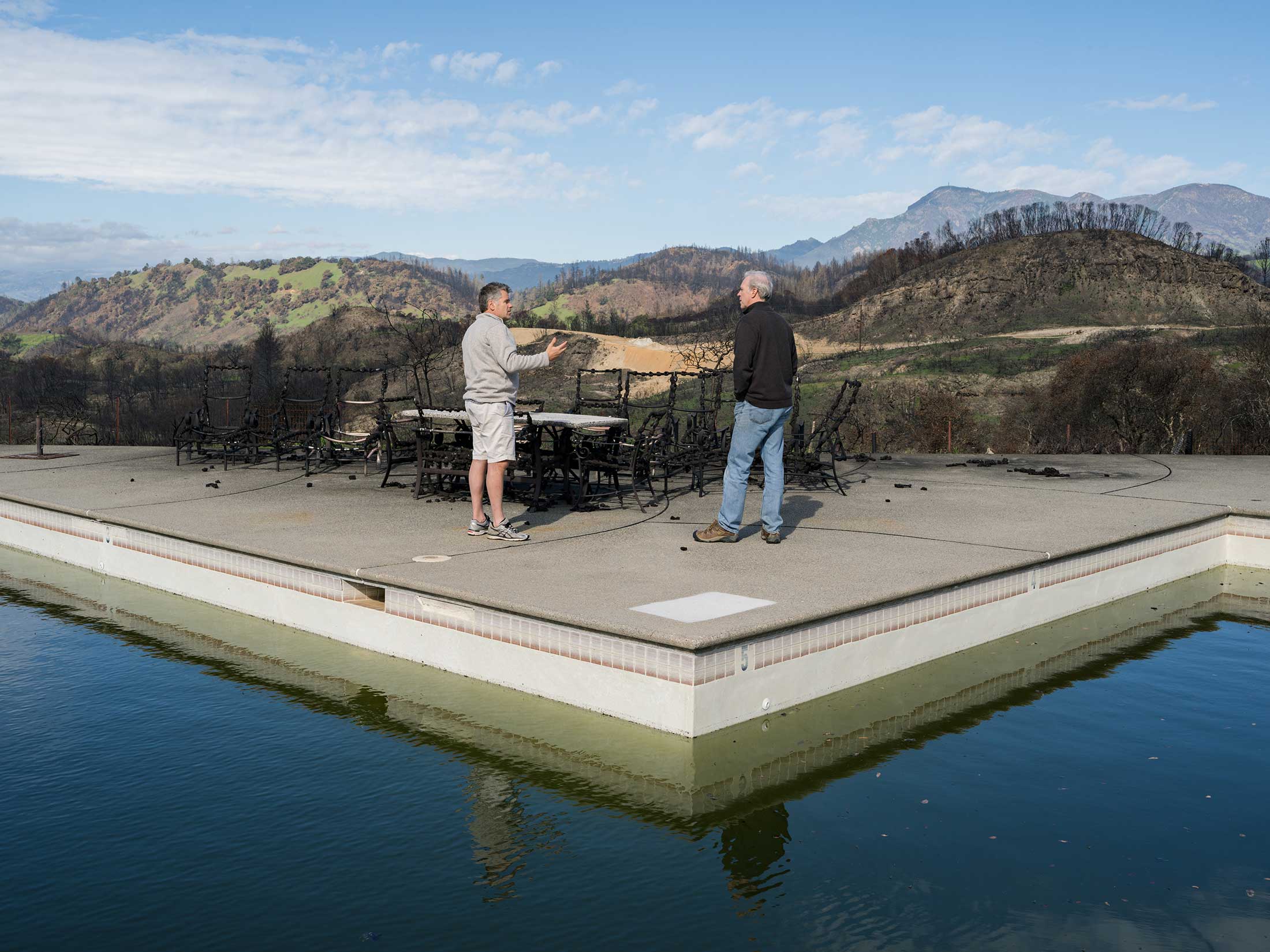 Derek Webb (left) and a potential investor discuss whether to buy the burned Mayacamas Ranch and make it a new resort. Webb was able to save his own nearby ranch.